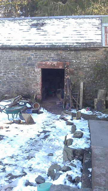 Barn butting up to corner house